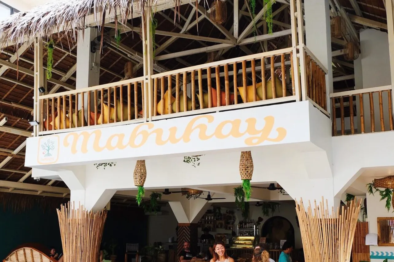The open-air Happiness restaurant under a thatched roof