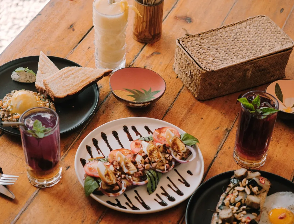 Sharing plates and drinks on the table at Happiness Goodies, Siargao