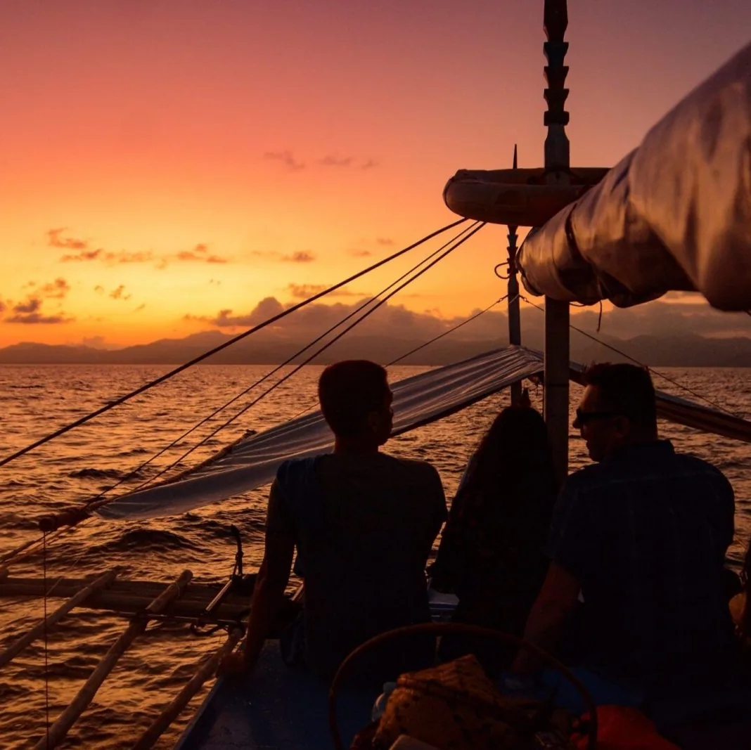 Guests on a boat at sunset