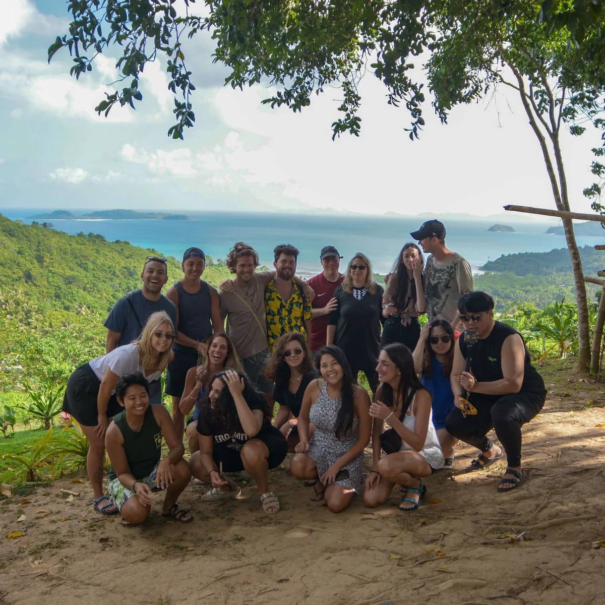 Guests posing at a viewpoint above the sea