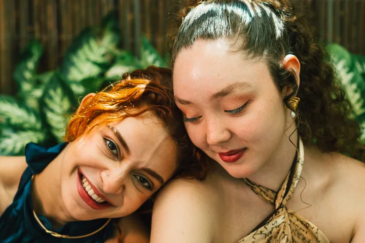 Friends smiling together in a tropical garden
