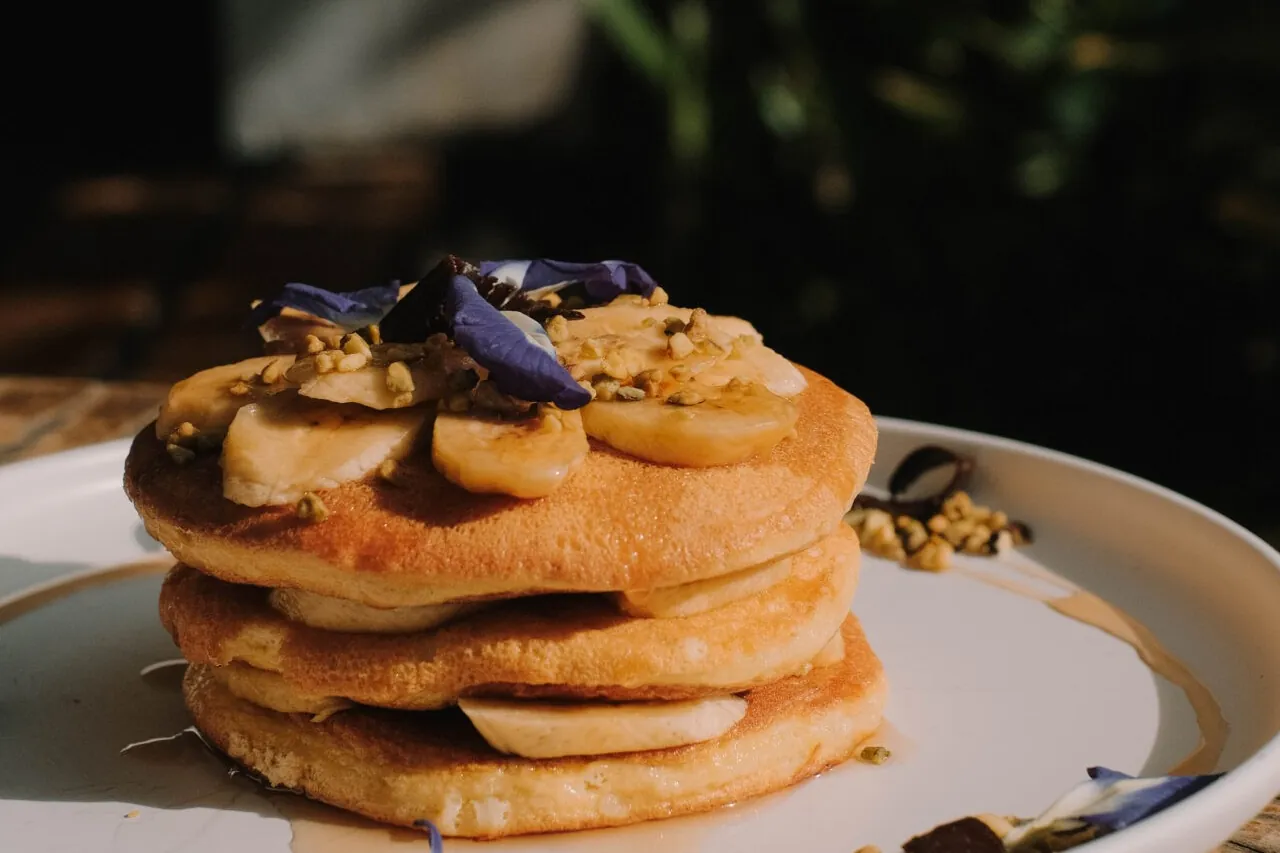 A stack of pancakes with fresh toppings at Goodies