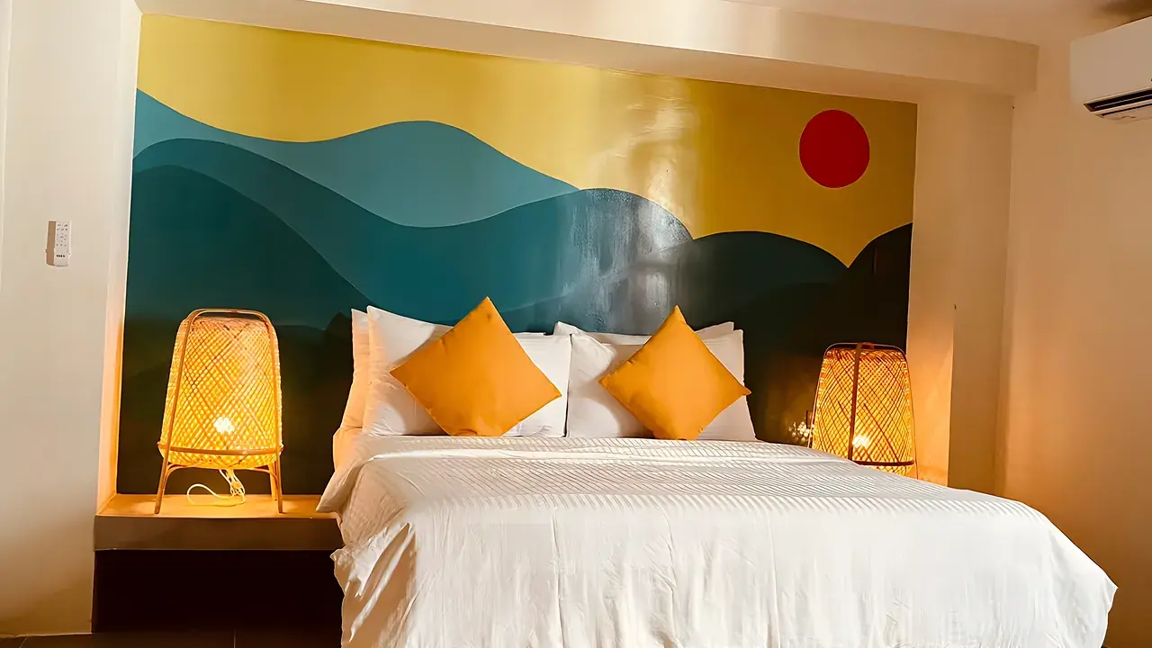 A private room with a teal feature wall and a mural