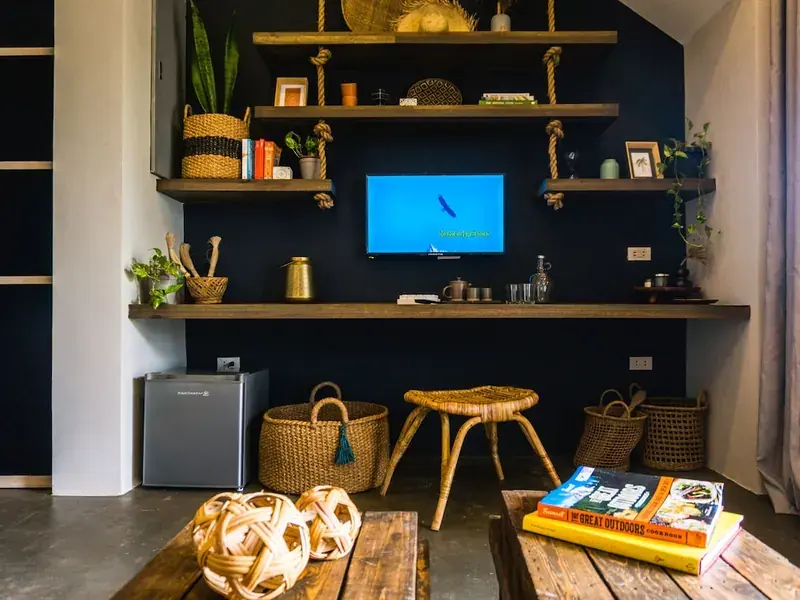 A villa living room with open shelves and woven baskets