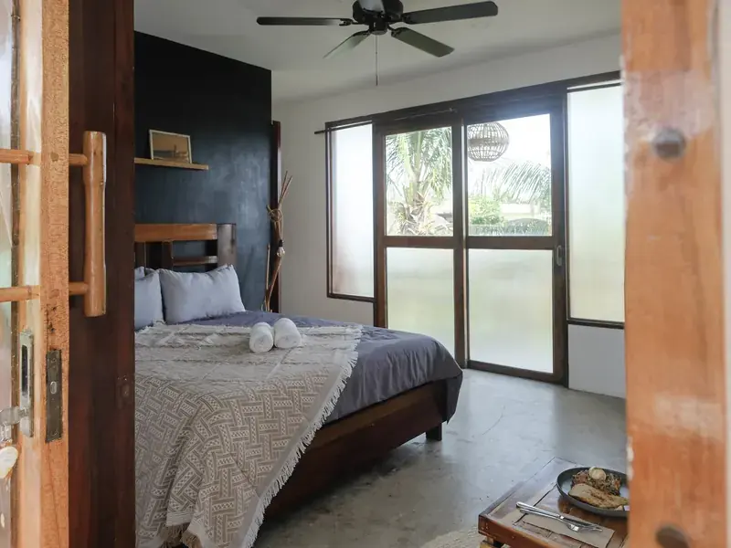 A double room with dark wood and a wide window